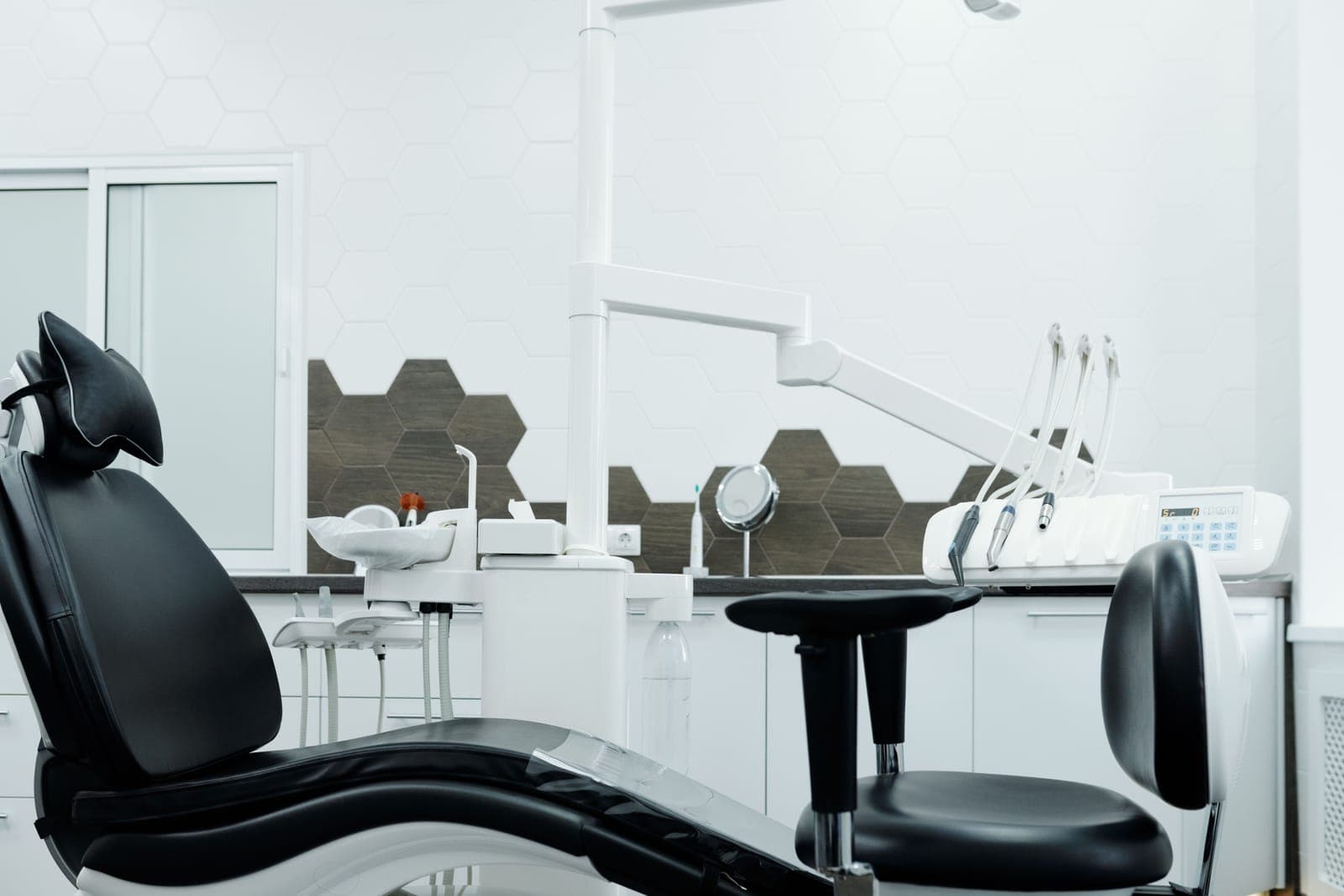 An office chair and a stool side by side in a room