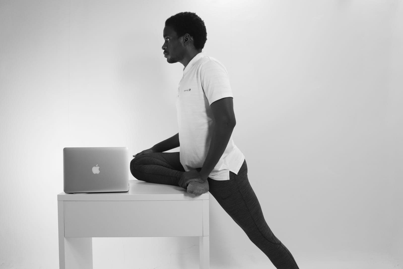 Person standing up from a desk to stretch