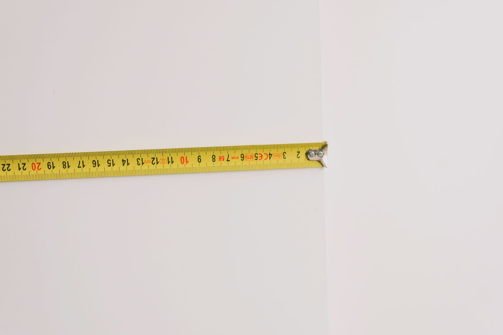 A ruler held against a wall to measure height