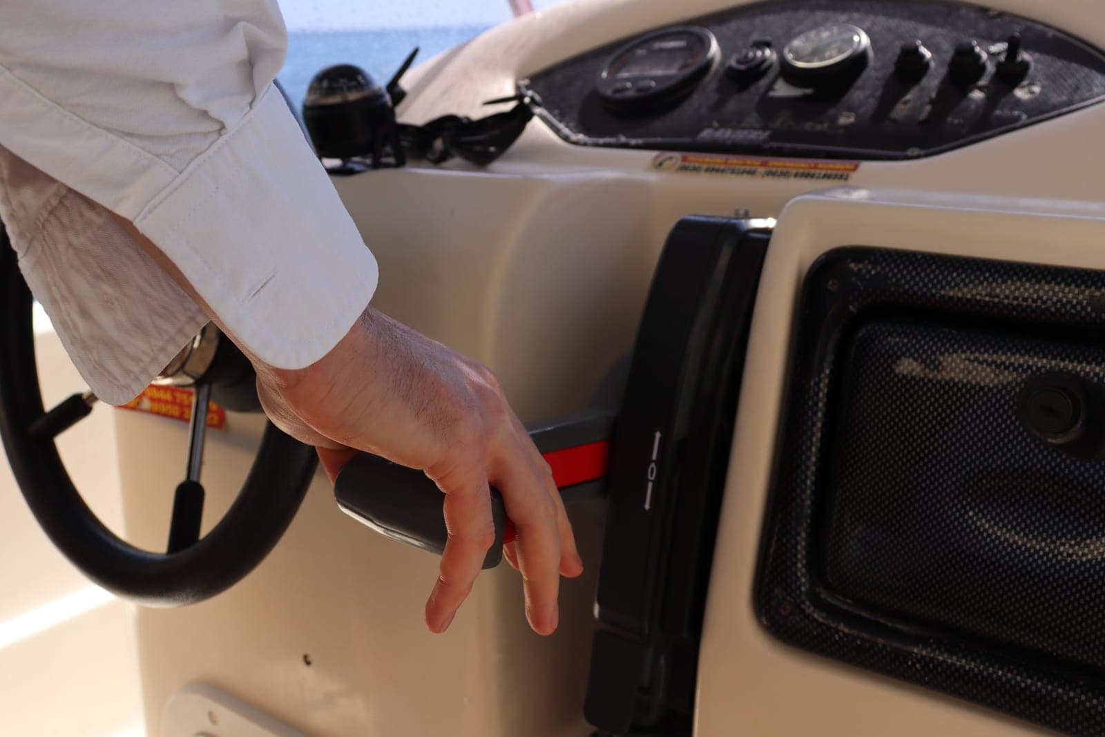 Hand adjusting the height lever under an office chair seat