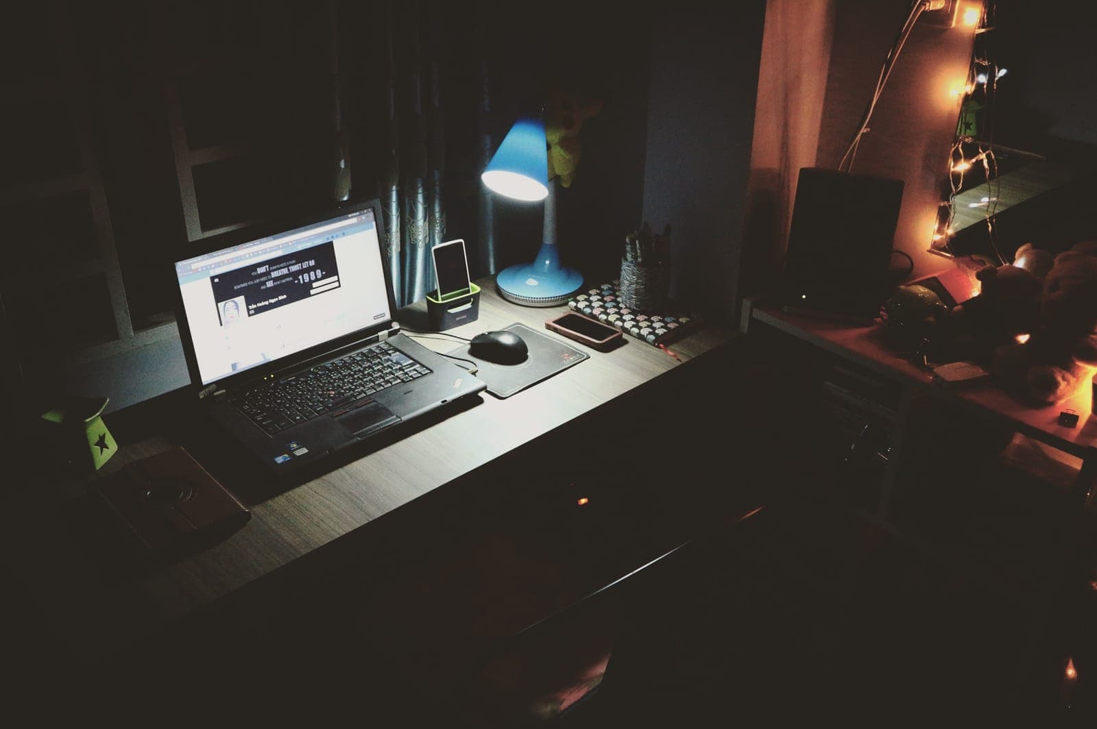 A home office desk in late afternoon light with a laptop and mug