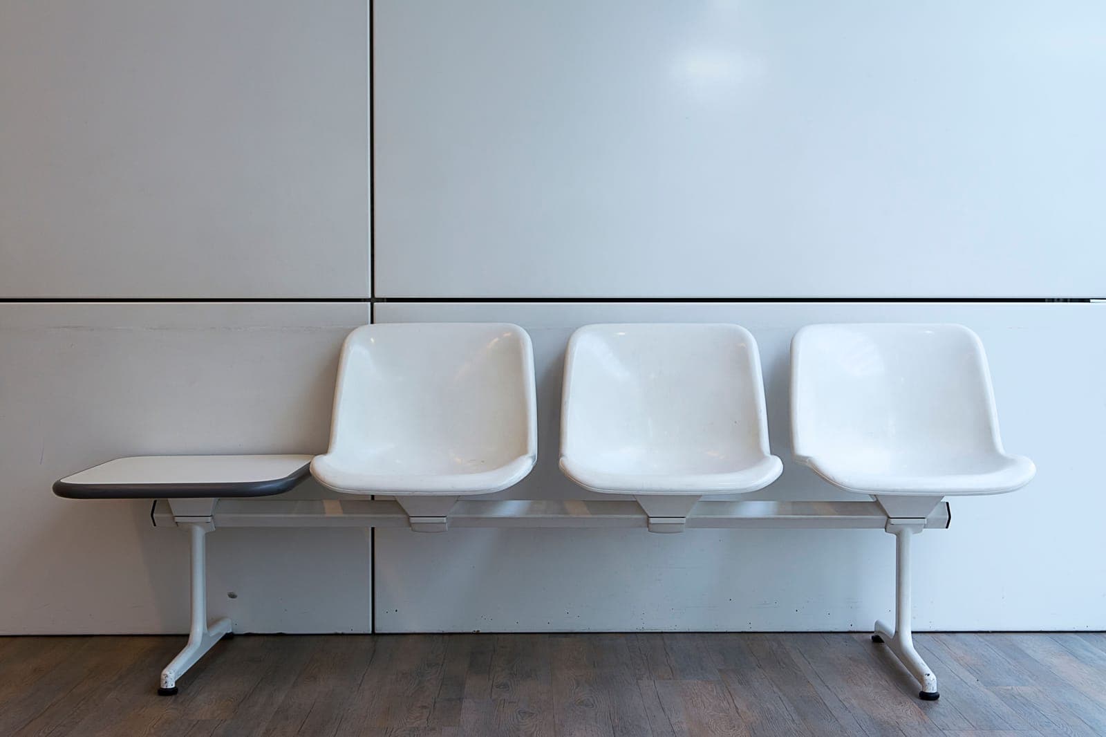 Several office chairs lined up against a wall